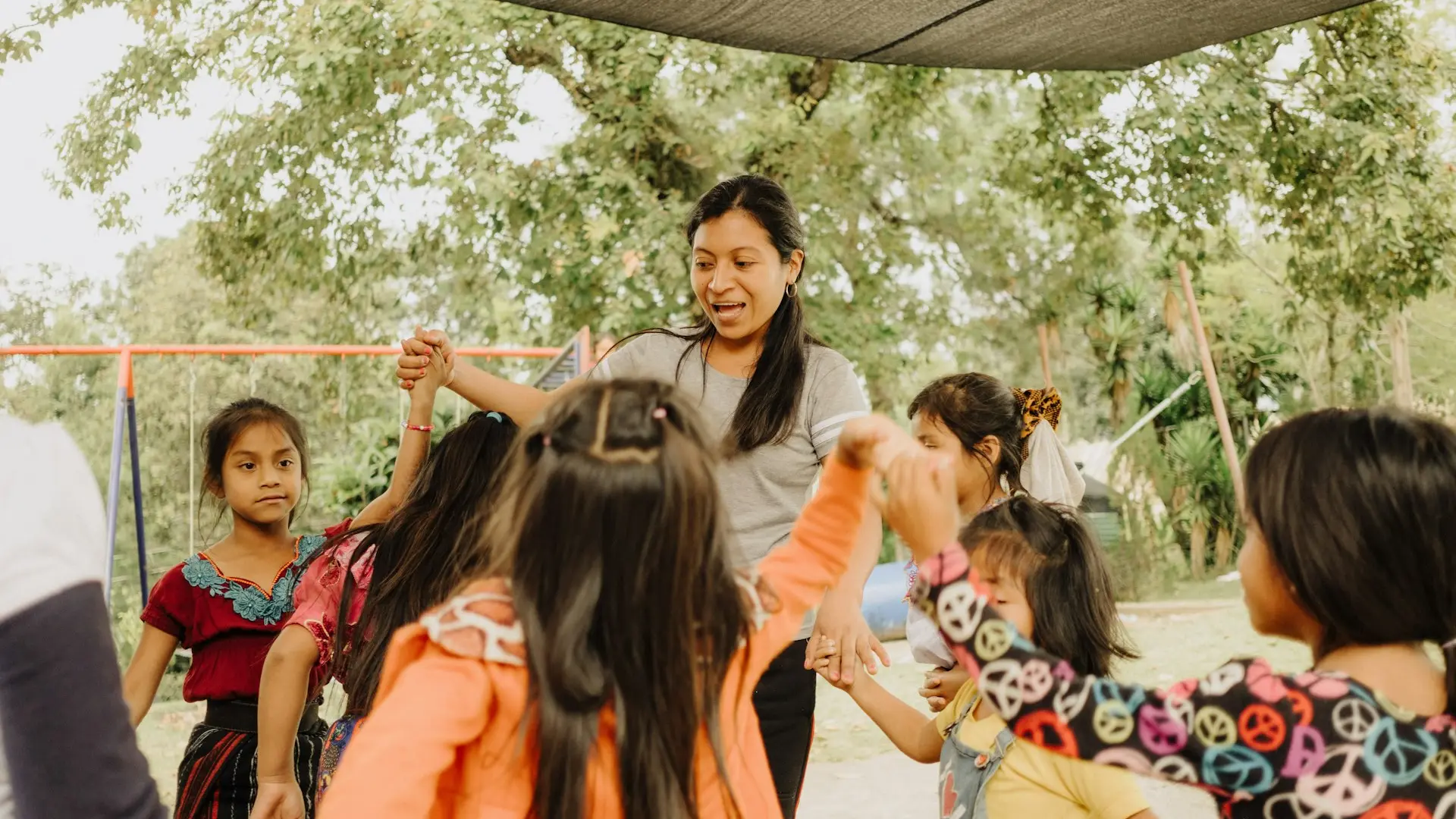 a group of young children standing around each other